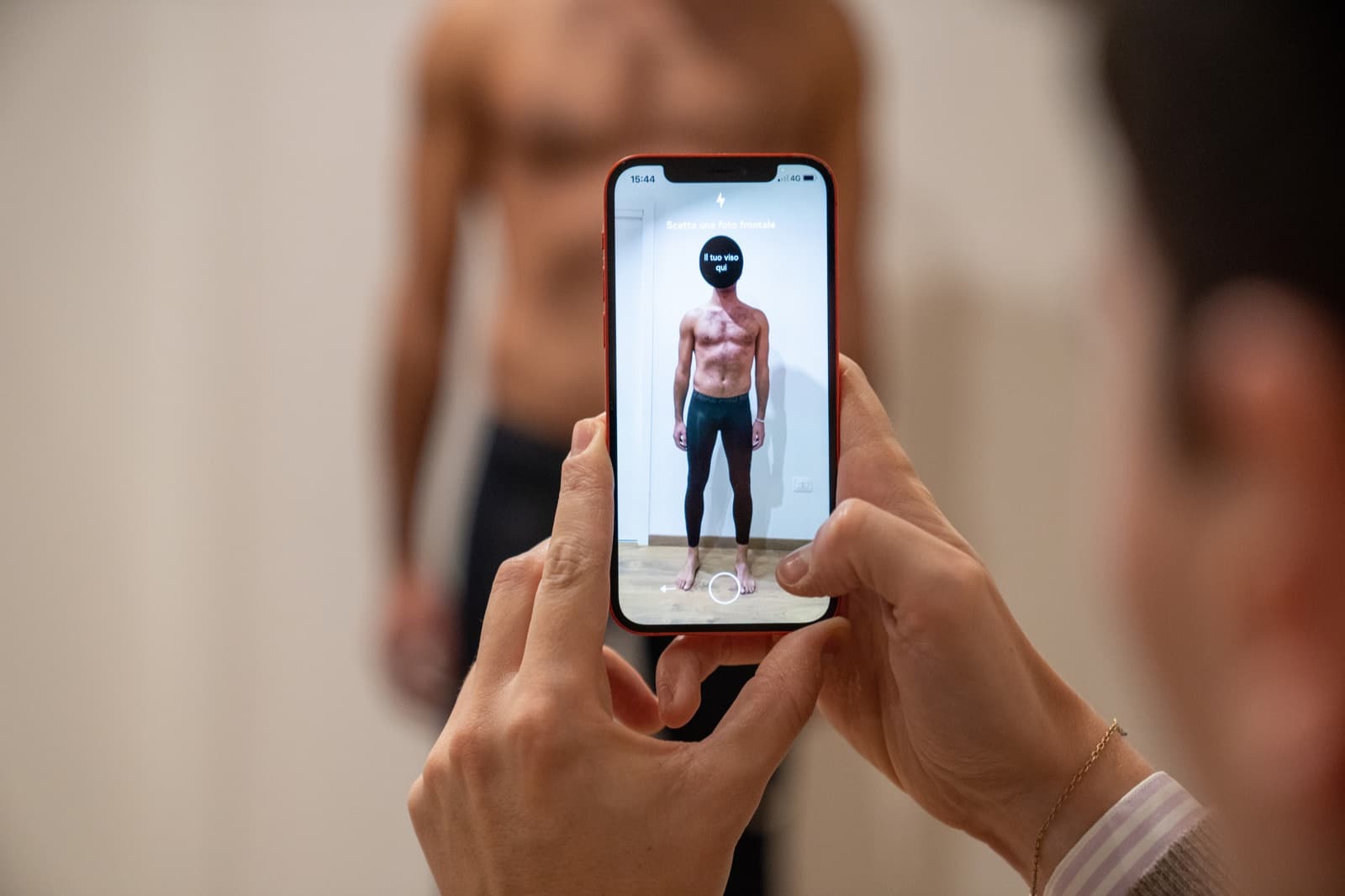 A phone capturing a full-body scan that becomes the member's digital avatar