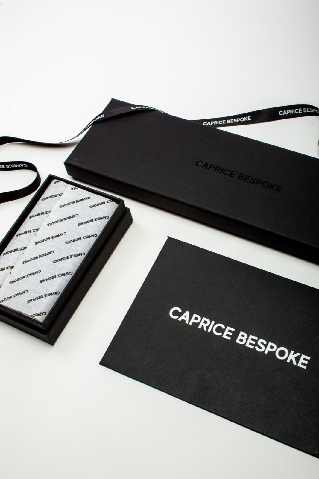 A Caprice Bespoke order in branded packaging with tissue and ribbon — proof of a bespoke purchase